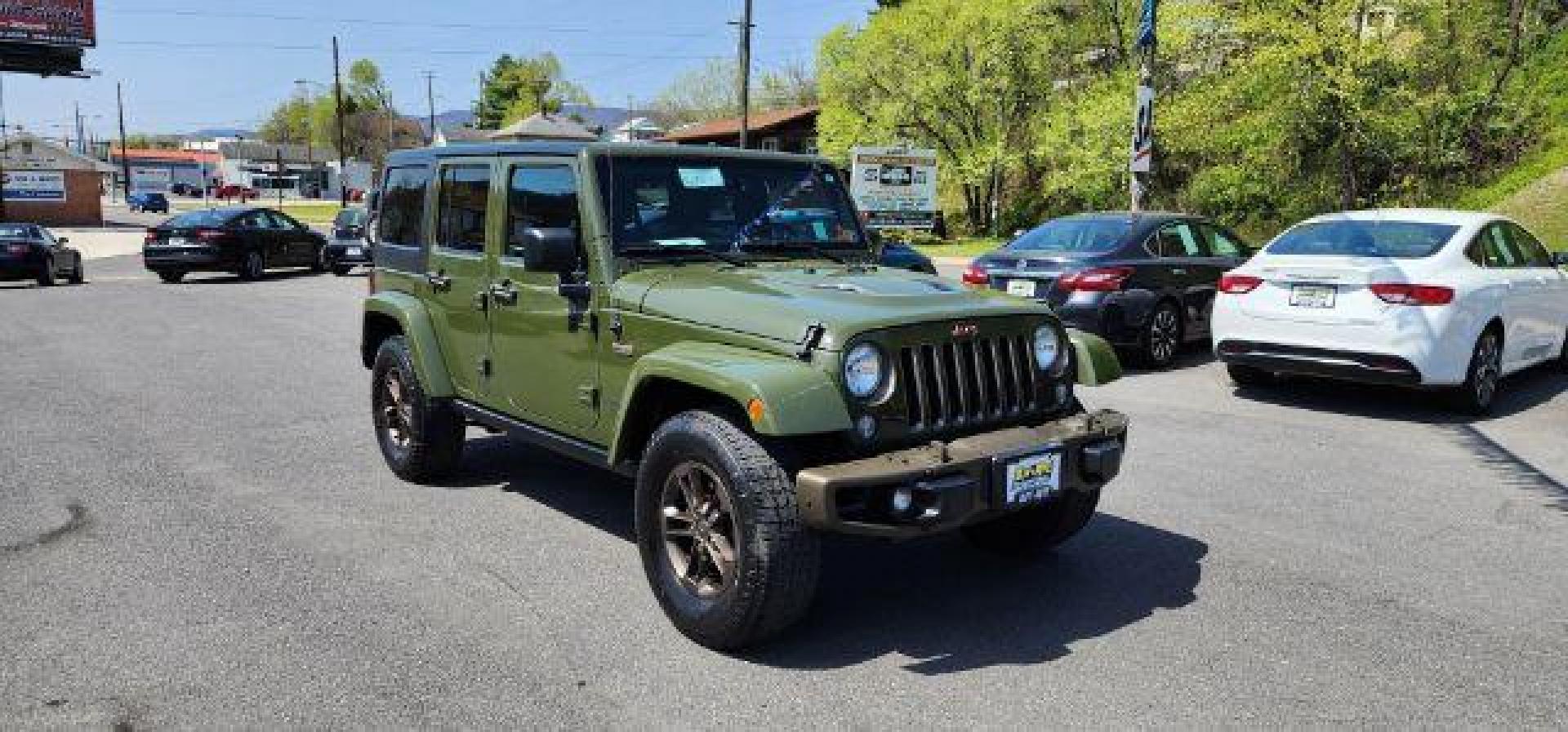 2016 GREEN /Leather Black Jeep Wrangler Unlimited Sahara 4WD (1C4BJWEG8GL) with an 3.6L V6 engine, AT transmission, located at 353 S. Mineral St., Keyser, WV, 26726, (304) 788-7887, 39.436451, -78.981674 - Photo#0
